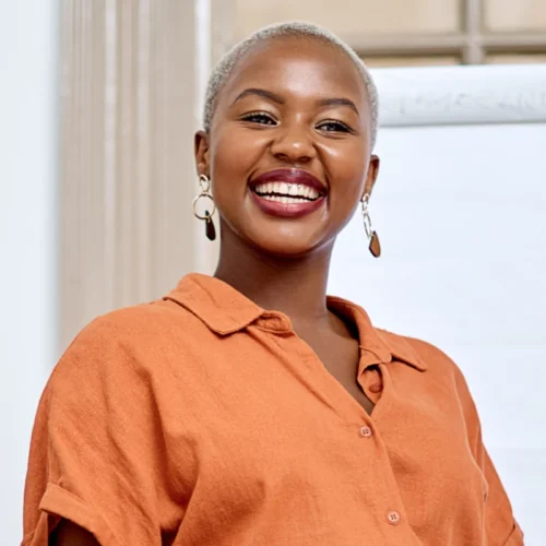Smiling woman wearing an orange shirt
